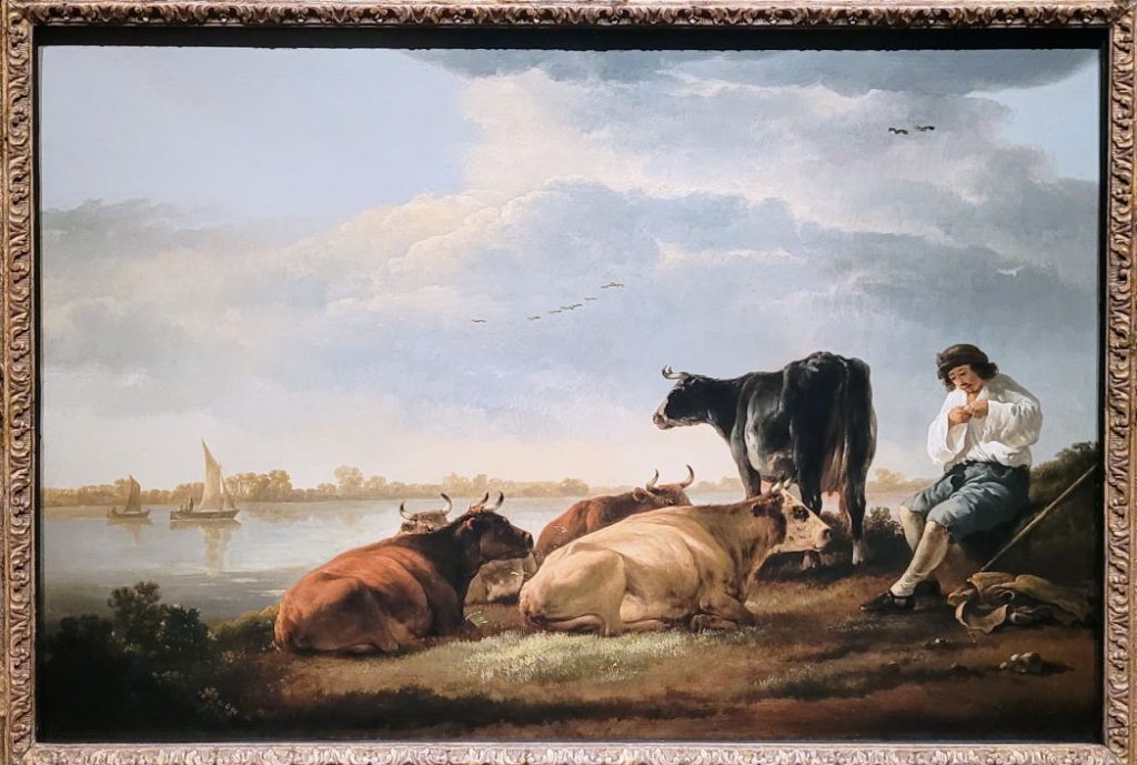 Rivierlandschap met herder en koeien